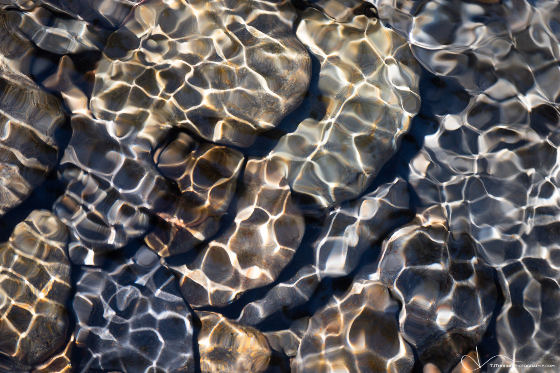 abiqua, abstract, oregon, pebbles, sunlight, water, ebb and flow, ebb, flow, blue, brown, orange, white, horizontal