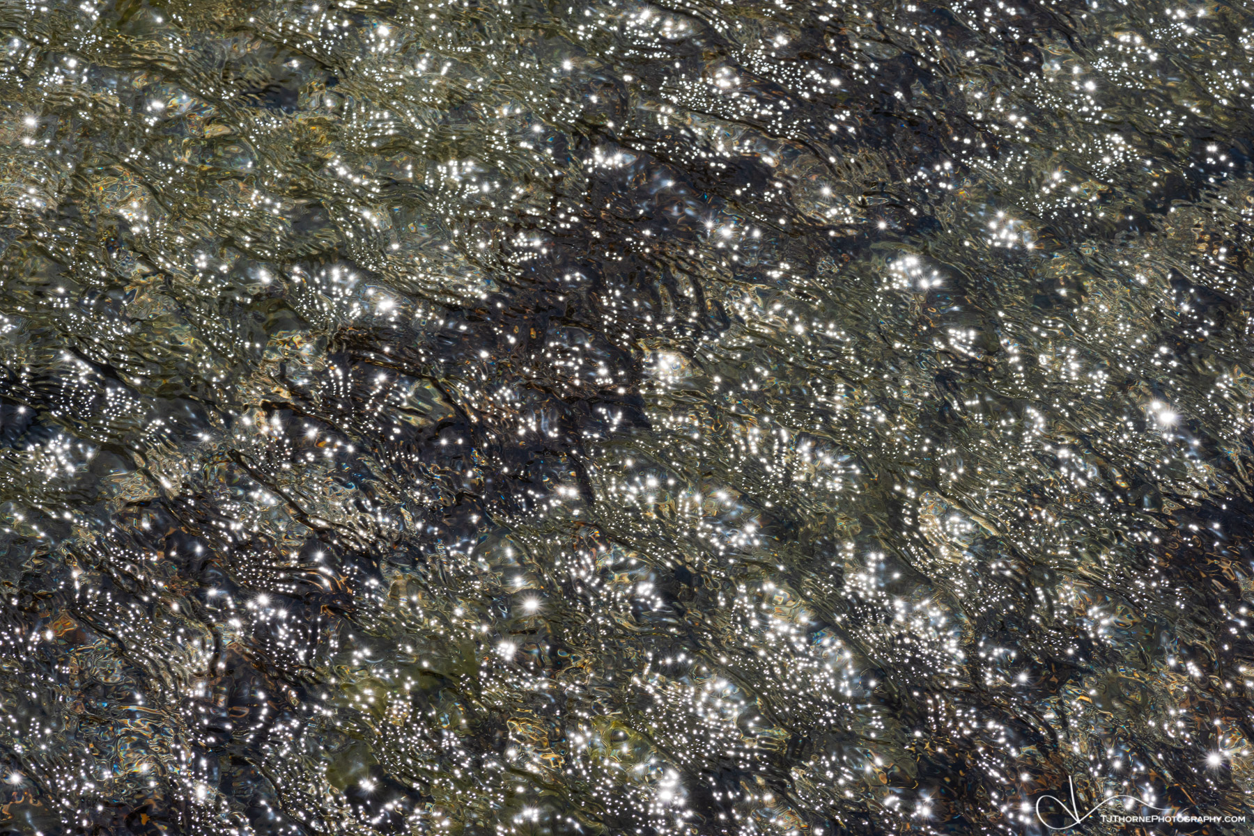 An abstract of direct light on windblown water on the Oregon Coast.